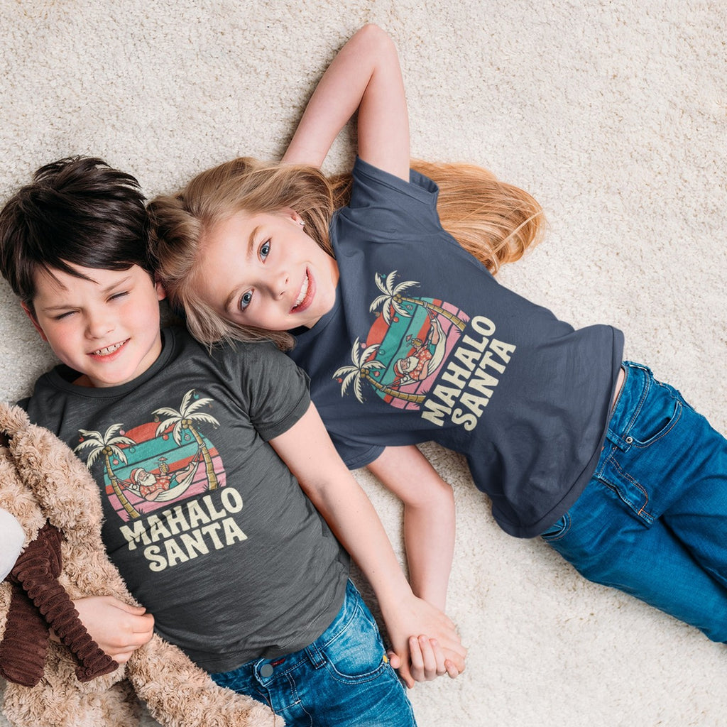 On-model lifestyle photo of the Mahalo Santa Hawaiian Christmas Kids Hawaiian T-shirt