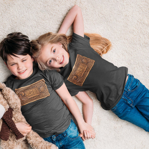 On-model lifestyle photo of the Carved Wood Hawaii Wave Turtle Tiki Panel Kids Hawaiian T-shirt