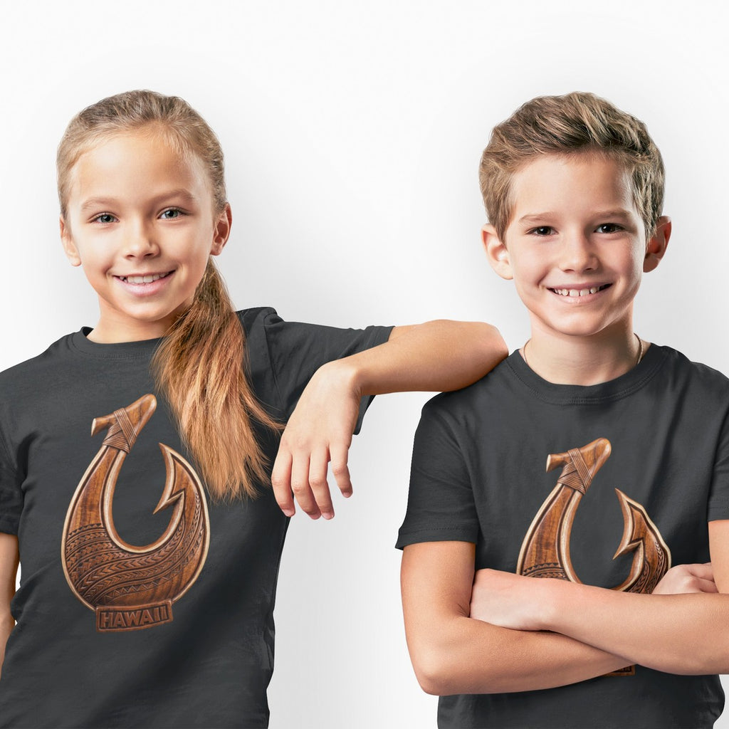 On-model lifestyle photo of the Makau Hawaiian Fish Hook Carved Wood Polynesian Kids Hawaiian T-shirt