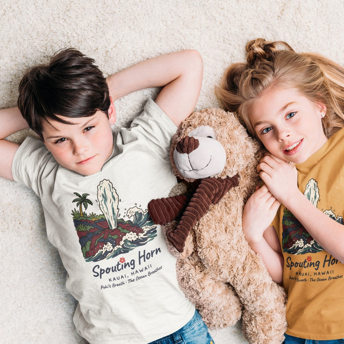 On-model lifestyle photo of the Spouting Horn Kauai Hawaii Vintage Travel Graphic Kids Hawaiian T-shirt