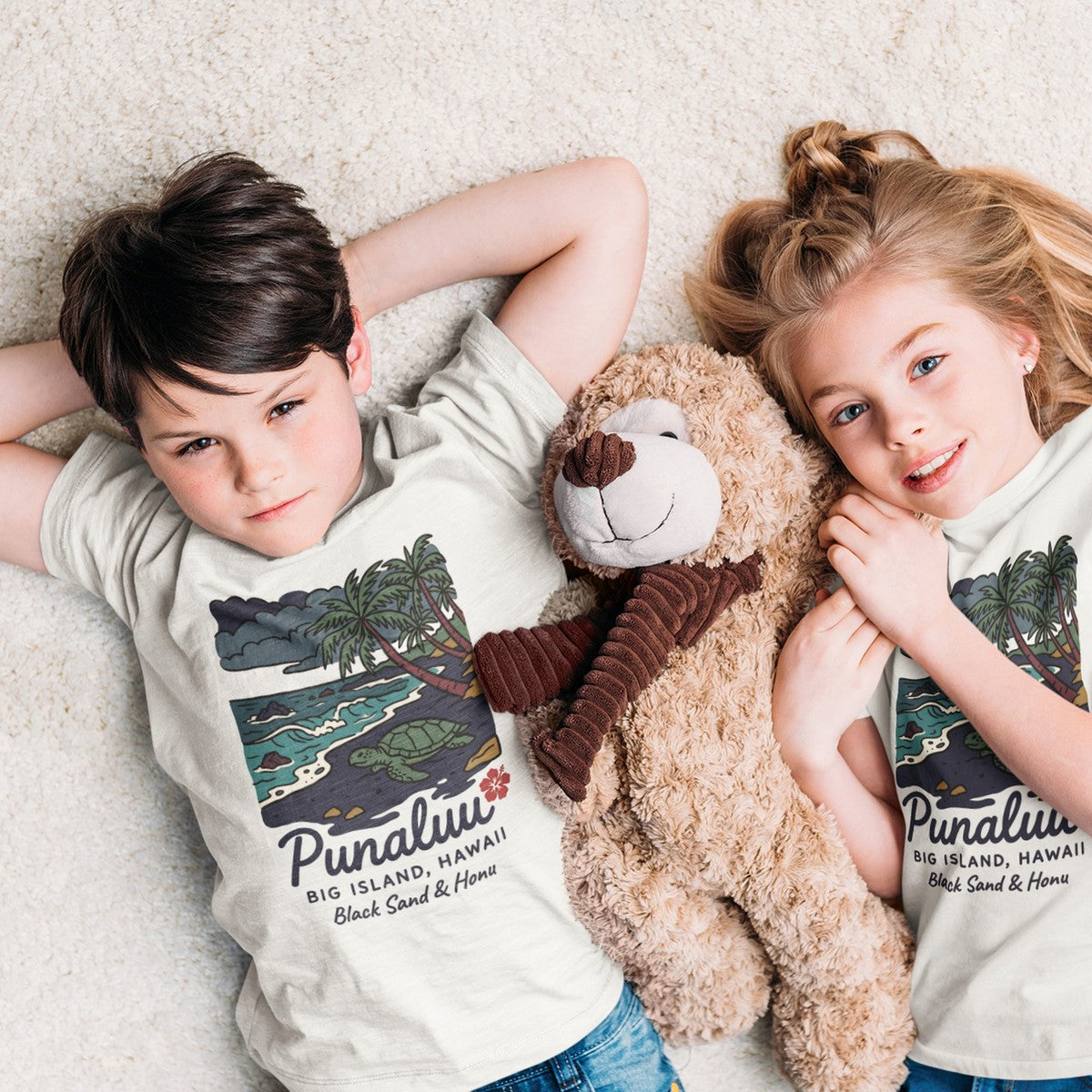 On-model lifestyle photo of the Punaluu Black Sand Beach Big Island Hawaii Vintage Travel Graphic Kids Hawaiian T-shirt