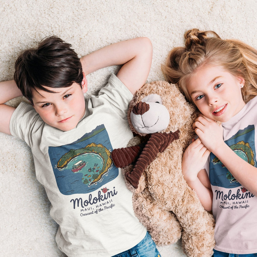 On-model lifestyle photo of the Molokini Maui Hawaii Vintage Travel Graphic Kids Hawaiian T-shirt