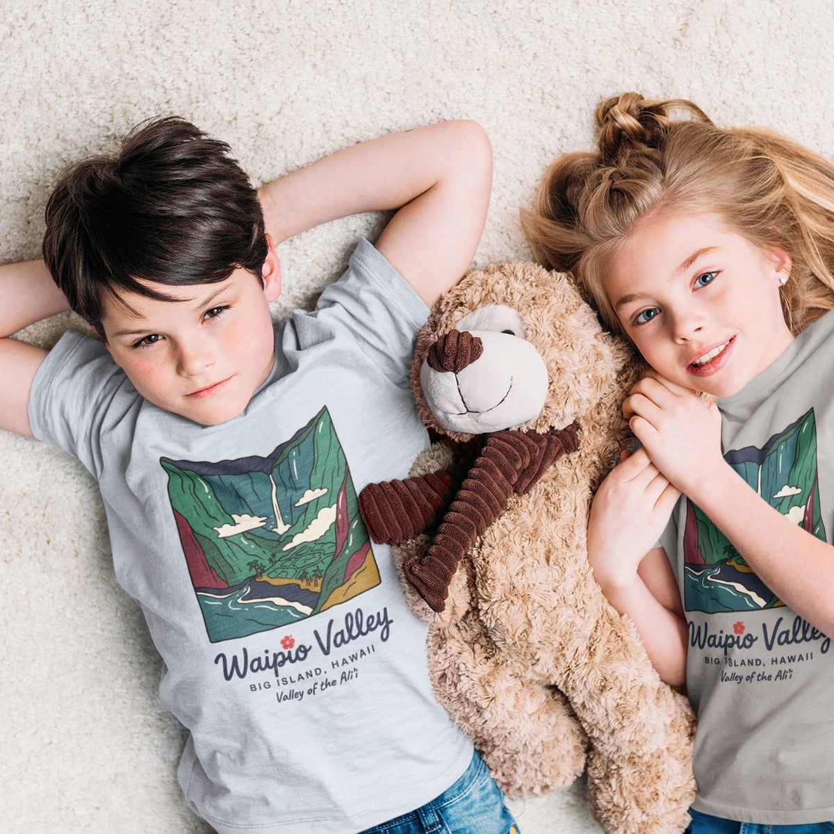 On-model lifestyle photo of the Waipio Valley Big Island Hawaii Vintage Travel Graphic Kids Hawaiian T-shirt