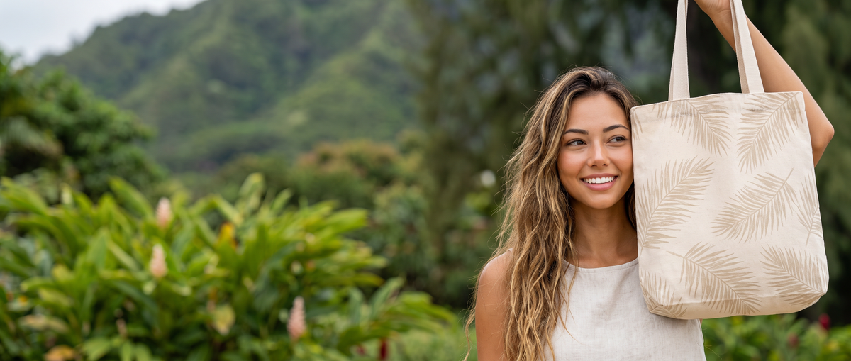 Hawaiian Dreams Totes – woman holding a tropical canvas tote in a Hawaiian garden